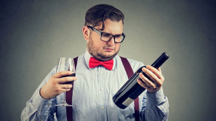 A man trying to choose a good wine