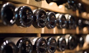 Bottles stacked in a cellar for the iDealwine blog