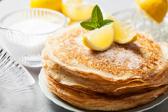 Stack of pancakes with lemon and sugar for wine pairing ideas for Shrove Tuesday