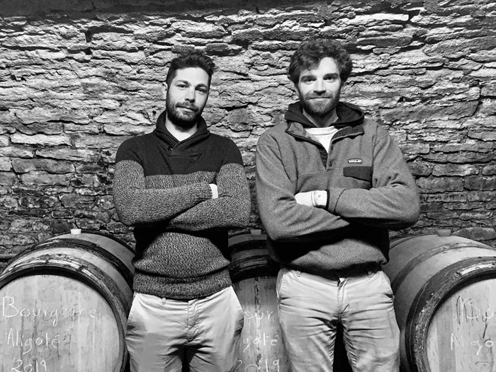 Alexandre and Pierre-Alexandre of Maison A&S leaning on wine barrels