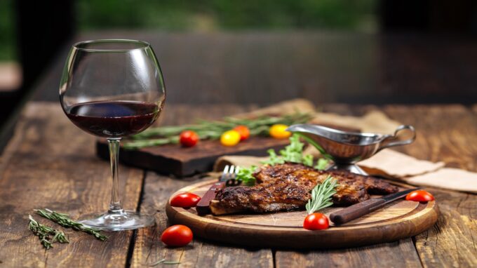 seared meat with a glass of Pinot Noir