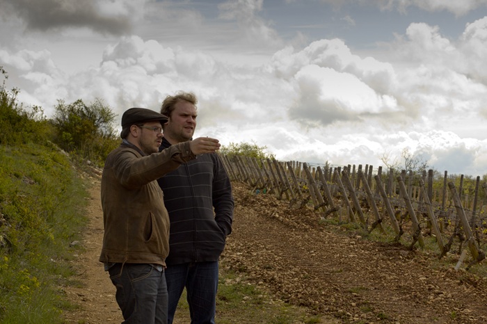 Romain (right) and Jean-Guillaume Chapuis (left) with vines to the right of them in the photo