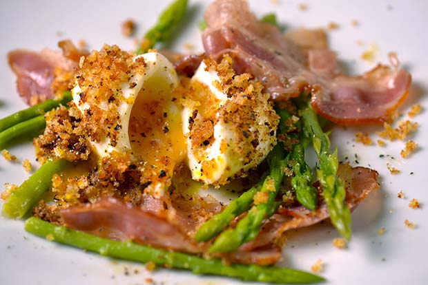 soft-boiled egg, asparagus and ham on a plate
