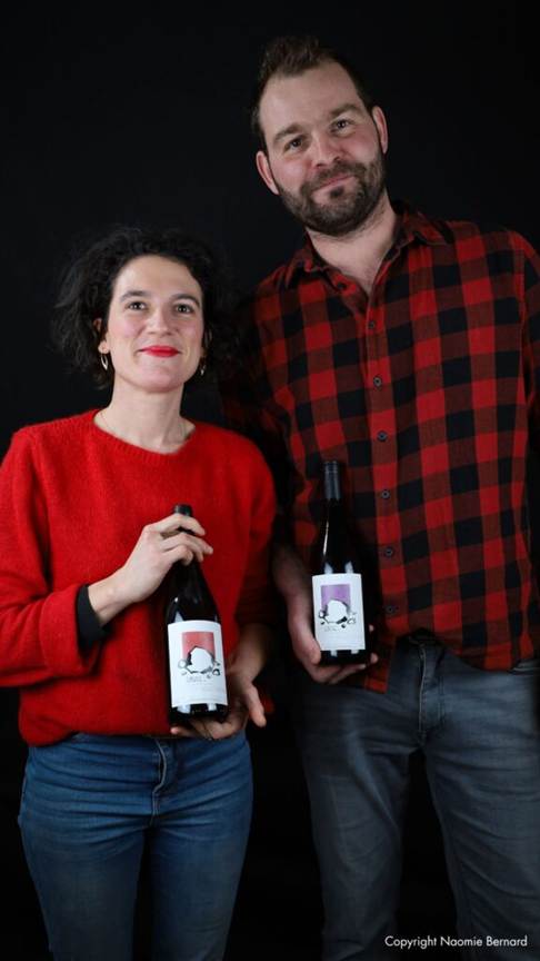 Romain and Eugénie with a bottle of wine