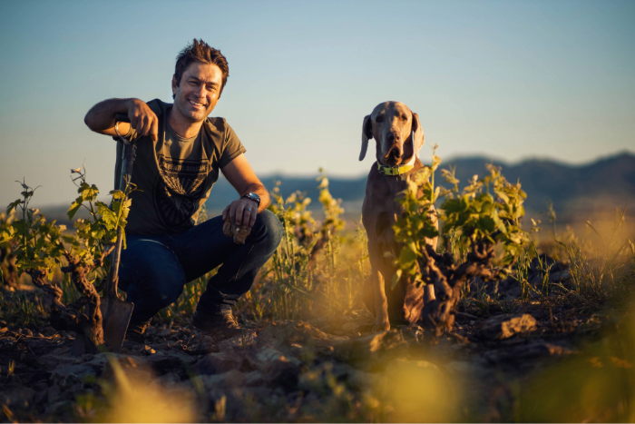 Jean Smit, the winemaker at Damascene, and his dog in the vineyard